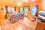 Main Level Bedroom Features a King Size Bed, Flat Screen Tv & Access to Covered Deck